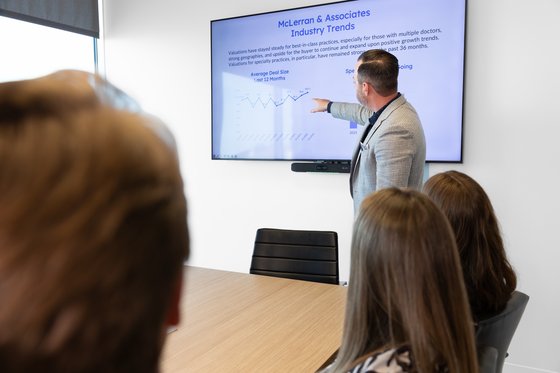 A McLerran advisor presenting industry trends and deal-size data to a room of practice owners.